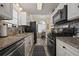 Well-equipped kitchen featuring stainless steel appliances, granite countertops, and white cabinets at 536 Crestridge Ct, Stone Mountain, GA 30083