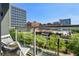 Private balcony overlooking city buildings and lush landscaping at 620 Glen Iris Ne Dr # 410, Atlanta, GA 30308
