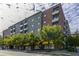 Multi-story apartment building with balconies and tree-lined street at 620 Glen Iris Ne Dr # 410, Atlanta, GA 30308