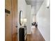 Hallway with wood floors, a mirror, and access to rooms, showcasing a modern design at 620 Glen Iris Ne Dr # 410, Atlanta, GA 30308