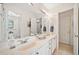 Well-lit bathroom with double vanity, large mirror, and separate water closet at 7420 Colony Ct, Cumming, GA 30041