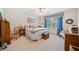 Comfortable bedroom with ceiling fan, bright window with drapes and carpeted floors at 7420 Colony Ct, Cumming, GA 30041