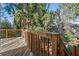 Side view of the wooden deck showcasing the wooden railing and the surrounding greenery at 7420 Colony Ct, Cumming, GA 30041