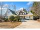 Charming home featuring a stone facade, well-manicured landscaping, and a spacious driveway at 7420 Colony Ct, Cumming, GA 30041
