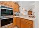 Gourmet kitchen showcasing stainless steel double ovens, wood cabinets, and light countertops at 7420 Colony Ct, Cumming, GA 30041