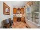 Home office featuring built-in cabinets, a desk, and a window with natural light at 7420 Colony Ct, Cumming, GA 30041