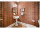 Charming powder room with unique wallpaper and a pedestal sink at 7420 Colony Ct, Cumming, GA 30041