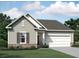 Charming single-Gathering home featuring a two-car garage, neutral siding, and well-maintained landscaping at 7770 Sudbury Cir, Covington, GA 30014