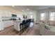 Modern kitchen boasts white cabinetry, granite countertops, stainless steel appliances, and bar seating at 7770 Sudbury Cir, Covington, GA 30014