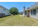 Backyard showing a lush lawn, mature trees, and vinyl siding at 811 Betsy Ross Trl, Hampton, GA 30228