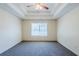 Neutral bedroom with tray ceiling, and a large window at 811 Betsy Ross Trl, Hampton, GA 30228
