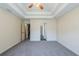 Spacious bedroom featuring tray ceilings, neutral walls, and plush carpeting at 811 Betsy Ross Trl, Hampton, GA 30228