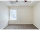 Bright, empty bedroom featuring clean neutral walls and carpet with white trim and a window at 811 Betsy Ross Trl, Hampton, GA 30228