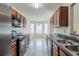 Efficient galley kitchen features stainless steel appliances and plenty of counter space at 811 Betsy Ross Trl, Hampton, GA 30228