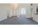 Open floor plan featuring a view of the foyer and dining area from the living room with carpet floors at 811 Betsy Ross Trl, Hampton, GA 30228