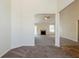Open-concept living room with plush carpeting and a view of the fireplace at 811 Betsy Ross Trl, Hampton, GA 30228