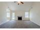 Cozy living room with plush carpeting, a fireplace, and access to the backyard through a glass door at 811 Betsy Ross Trl, Hampton, GA 30228