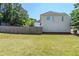 Large backyard with a wood fence, grassy lawn, and leafy trees at 811 Betsy Ross Trl, Hampton, GA 30228