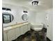 Large bathroom featuring double sinks, granite countertops, large tub and modern fixtures at 14 Craig Dr, Conyers, GA 30012