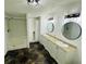 Modern bathroom with double sinks, updated fixtures, walk-in shower, and tile flooring at 14 Craig Dr, Conyers, GA 30012