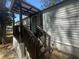 Exterior of home with covered porch and wooden stairs at 14 Craig Dr, Conyers, GA 30012