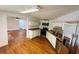 Well-lit kitchen featuring stainless steel appliances, white cabinets, and wood flooring at 14 Craig Dr, Conyers, GA 30012
