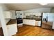 Kitchen featuring stainless steel appliances, white cabinets, and wood flooring at 14 Craig Dr, Conyers, GA 30012