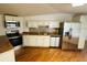 Spacious kitchen featuring stainless steel appliances, white cabinets, and wood flooring at 14 Craig Dr, Conyers, GA 30012