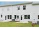 Backyard view of a home featuring a lawn, patio, and multiple windows for natural light at 1573 Aiden Way # 37, Conyers, GA 30013