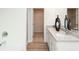 Modern bathroom with double sinks, granite countertop, and view to a walk-in closet at 1573 Aiden Way # 37, Conyers, GA 30013