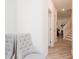 Bright hallway features a tufted chair, mirror, and views into adjacent rooms, offering a blend of comfort and style at 1573 Aiden Way # 37, Conyers, GA 30013