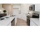 Bright kitchen features stainless steel appliances, stone countertops, and an island with a double sink at 1573 Aiden Way # 37, Conyers, GA 30013