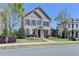 Elegant two-story home featuring a brick facade, manicured landscaping at 4030 Spencer Green, Cumming, GA 30040
