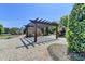 Wooden pergola and stone fireplace with paved patio area at 4030 Spencer Green, Cumming, GA 30040