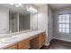 Spacious bathroom featuring double sinks, a large mirror, and a separate shower and tub at 1241 Hogan Ridge Ct, Grayson, GA 30017