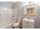 A well-lit bathroom featuring a tub/shower combo, ample counter space, and a mirrored medicine cabinet at 1241 Hogan Ridge Ct, Grayson, GA 30017