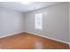 Empty bedroom featuring tile flooring, neutral paint, and natural light from a window at 1241 Hogan Ridge Ct, Grayson, GA 30017