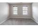 Neutral bedroom with light grey carpet, windows, and walls, creating a serene and comfortable atmosphere at 1241 Hogan Ridge Ct, Grayson, GA 30017