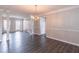 Open dining room with chandelier, columns and hardwood floors at 1241 Hogan Ridge Ct, Grayson, GA 30017