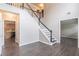 Open-concept foyer featuring hardwood floors, a staircase, and views into adjacent rooms at 1241 Hogan Ridge Ct, Grayson, GA 30017
