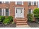 Close-up of the home's front entrance showcasing brick steps, white trim, and professionally landscaped yard at 1241 Hogan Ridge Ct, Grayson, GA 30017