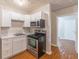 Efficient kitchen features white cabinets, stainless steel appliances, and durable countertops for easy maintenance at 1241 Hogan Ridge Ct, Grayson, GA 30017