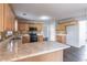 Kitchen showcasing stone counters and light wood cabinets at 1241 Hogan Ridge Ct, Grayson, GA 30017