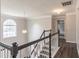 Well-lit upstairs landing with hardwood floors, white trim and chandelier at 1241 Hogan Ridge Ct, Grayson, GA 30017