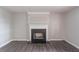 The living room features a decorative fireplace, light-grey walls, wood flooring, and baseboard electrical outlets at 1241 Hogan Ridge Ct, Grayson, GA 30017