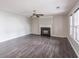 Cozy living room featuring a decorative fireplace, ceiling fan, gray walls, and natural light from the windows at 1241 Hogan Ridge Ct, Grayson, GA 30017