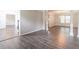 Elegant living room with hardwood floors, dining area, decorative columns, and ample space at 1241 Hogan Ridge Ct, Grayson, GA 30017