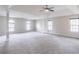 Expansive main bedroom featuring tray ceilings, carpet flooring, natural light, and architectural columns at 1241 Hogan Ridge Ct, Grayson, GA 30017