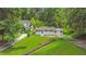 An aerial view of a single-story home on a green lawn, with surrounding trees and neighboring houses nearby at 2037 Lenox Ne Rd, Atlanta, GA 30324