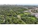 Aerial view showcases property with downtown Atlanta in background, surrounded by lush greenery at 2037 Lenox Ne Rd, Atlanta, GA 30324